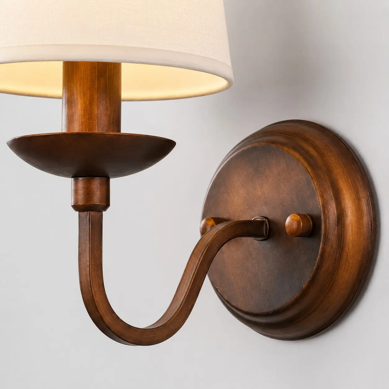 Close view of the curved arm and antique bronze finish